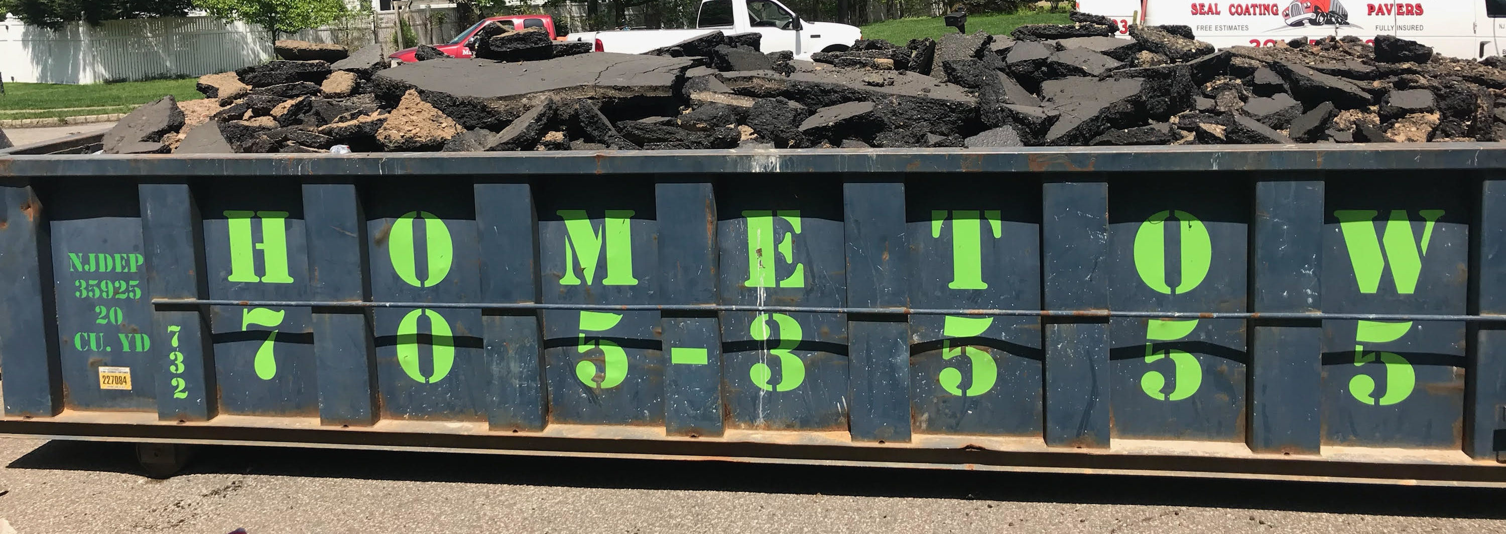 a dumpster overloaded with asphalt