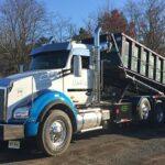 Hometown Waste dumpster truck off loading