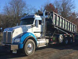 Hometown Waste dumpster truck off loading