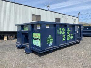 dumpster in front of trailer