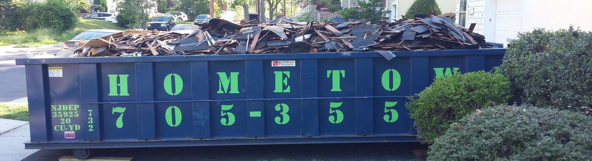 overfilled dumpster with roofing