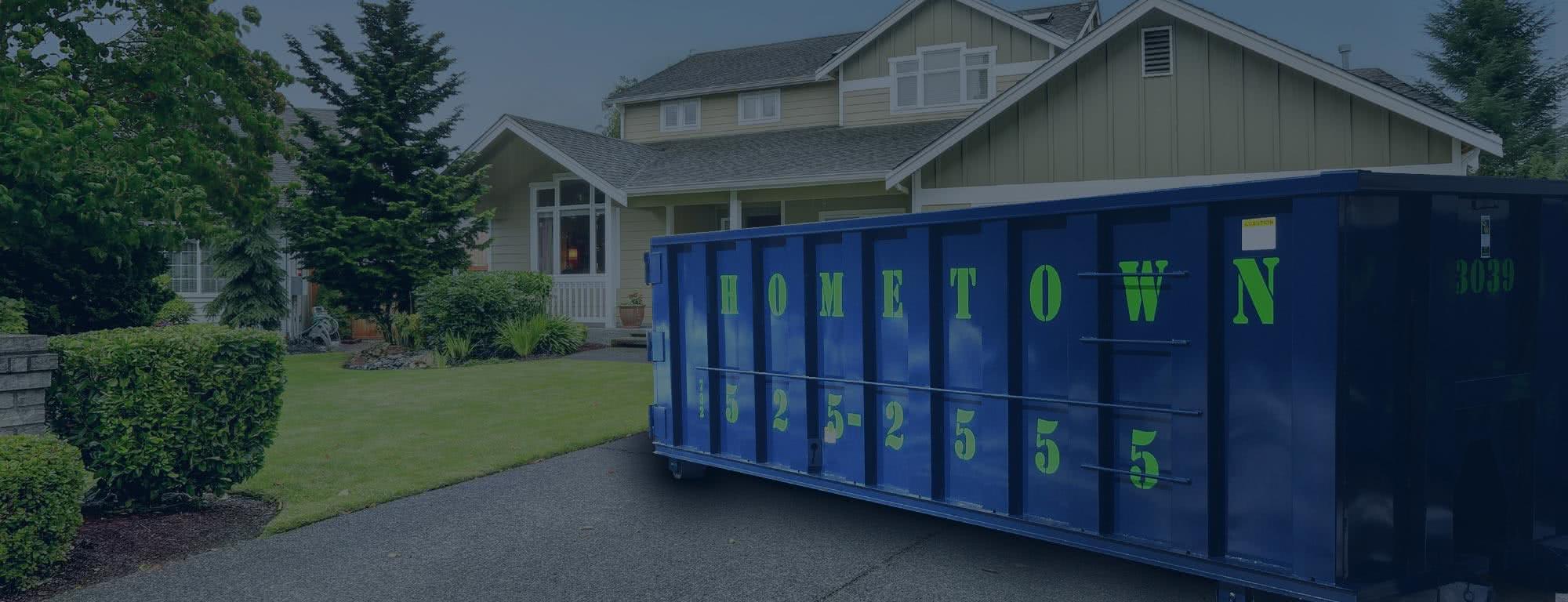 blue 30 yard dumpster in driveway