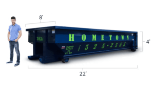 a man standing next to a 20 yard dumpster