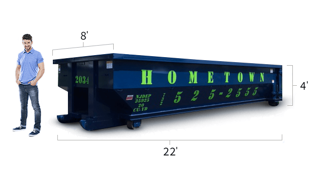 a man standing next to a 20 yard dumpster