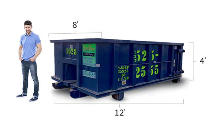 a man standing next to a 10 yard dumpster